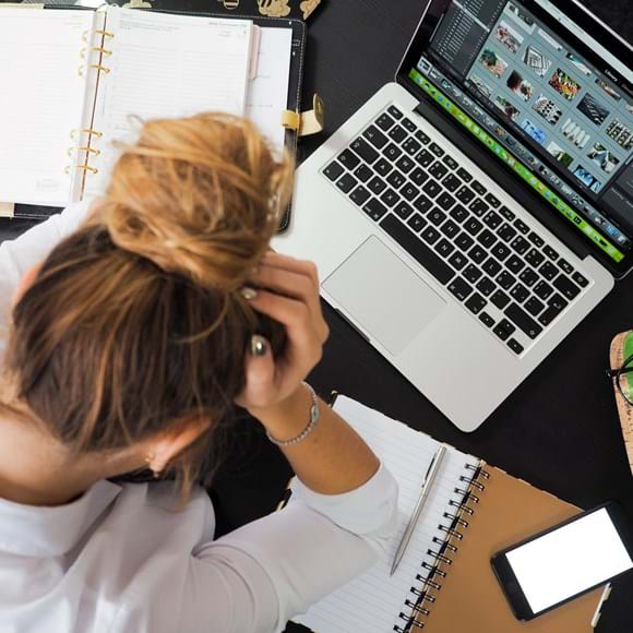 Stress At Work Showing A Lady With Head In Hands